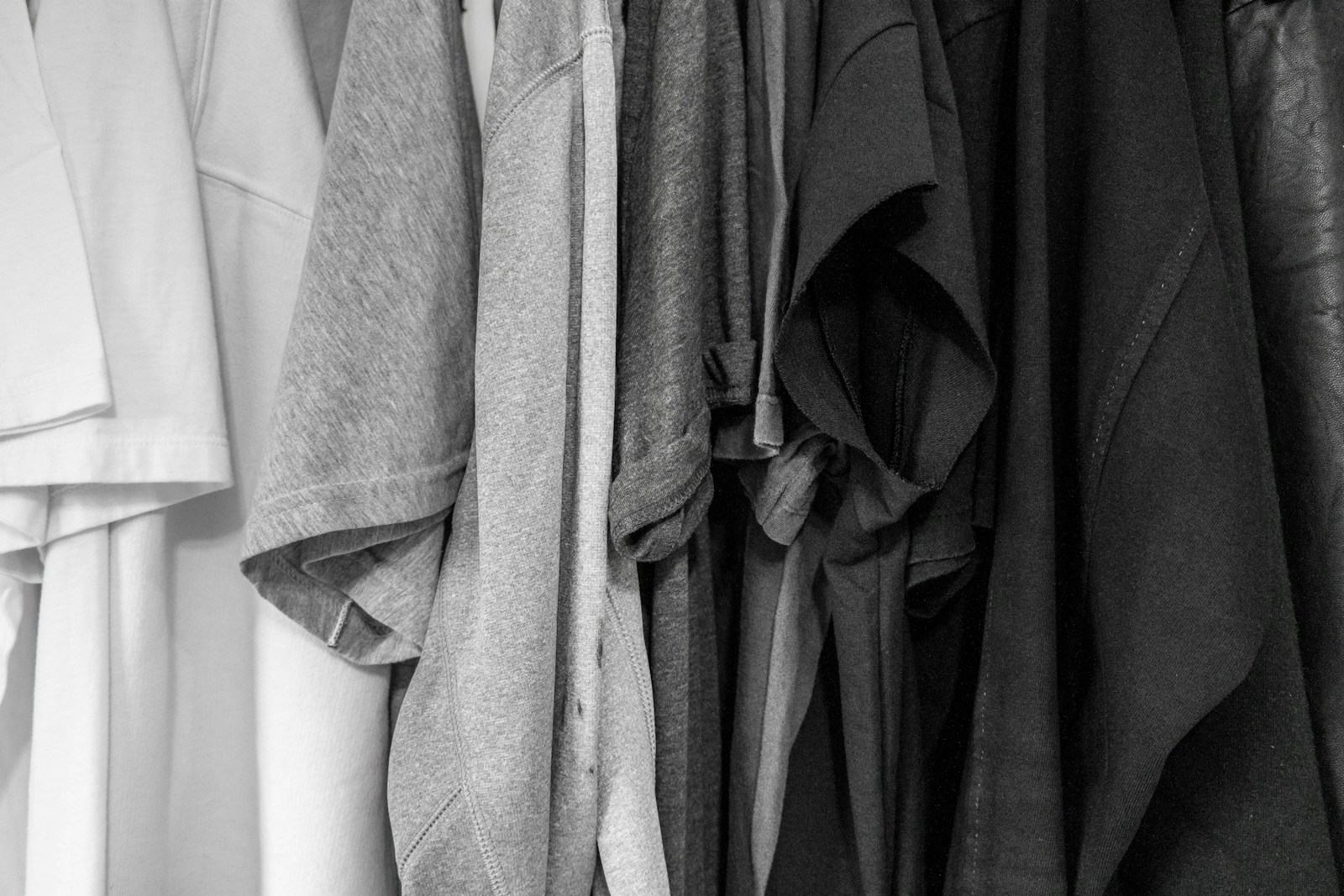 grayscale photography of assorted clothes